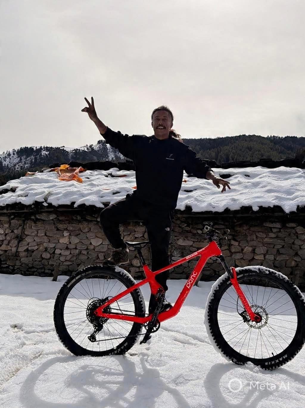 Standing on a red POC mountain bike in the snow
