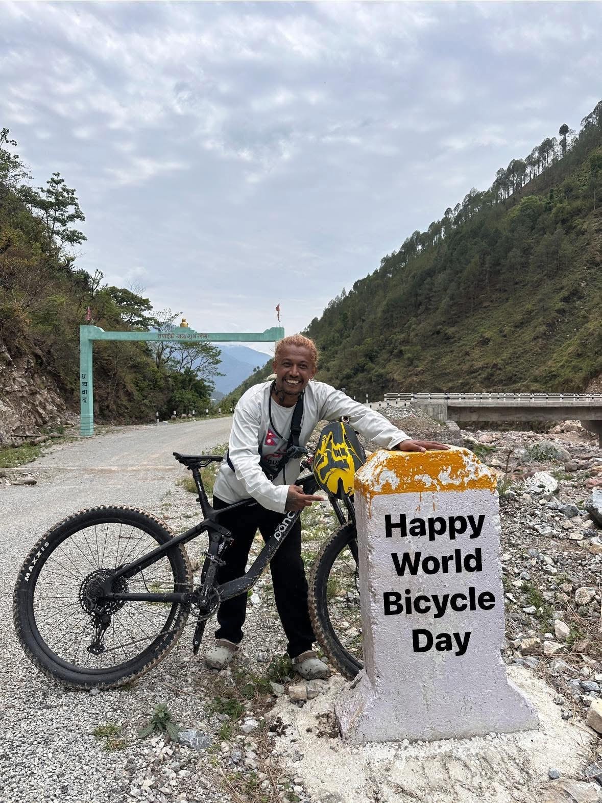 Posing at Happy World Bicycle Day milestone marker