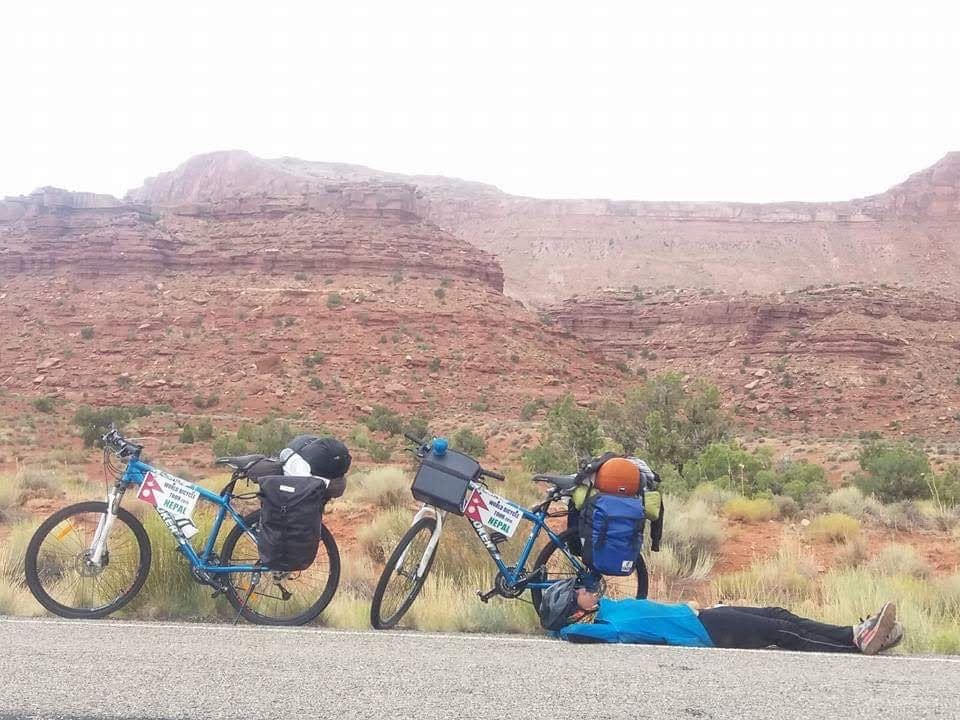 Cyclists resting in desert landscape